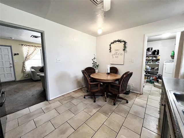 6338 Norman Rd, Warr Acres, OK 73122 - dining space featuring washer / clothes dryer, a ceiling fan, and light tile patterned floors