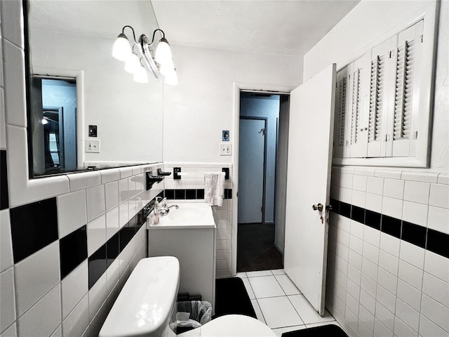 6338 Norman Rd, Warr Acres, OK 73122 - bathroom featuring tile walls, tile patterned flooring, vanity, a chandelier, and wainscoting