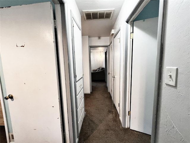 6338 Norman Rd, Warr Acres, OK 73122 - hallway featuring dark colored carpet
