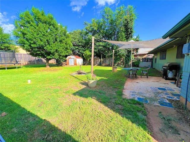 6338 Norman Rd, Warr Acres, OK 73122 - fenced backyard with a trampoline, a shed, and a patio