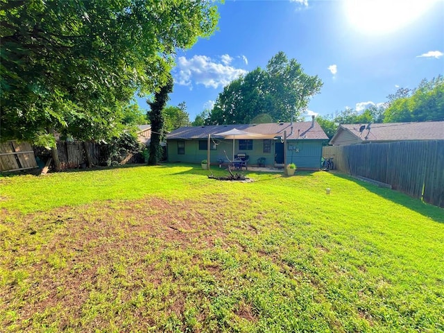 6338 Norman Rd, Warr Acres, OK 73122 - fenced backyard with a patio area