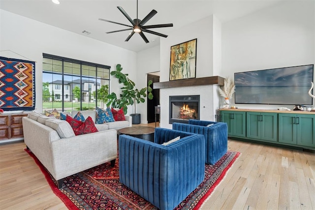 4504 SE 41st St, Moore, OK 73165 - living area featuring light wood-type flooring, a ceiling fan, and a glass covered fireplace