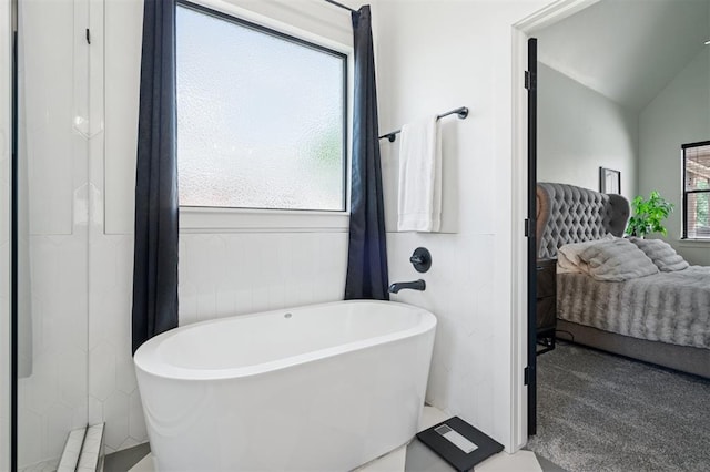 4504 SE 41st St, Moore, OK 73165 - bathroom featuring connected bathroom, a freestanding bath, vaulted ceiling, and wainscoting