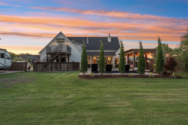 4504 SE 41st St, Moore, OK 73165 - back of house at dusk with a gate, a patio area, stairway, and roof with shingles