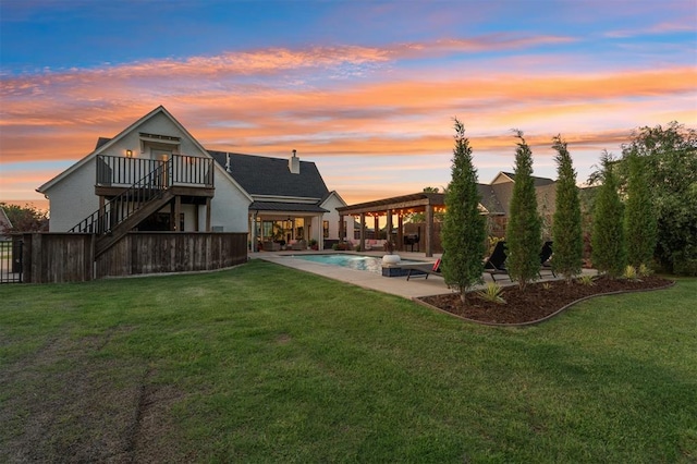 4504 SE 41st St, Moore, OK 73165 - back of property at dusk with stairs, a lawn, and a patio