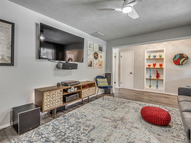 10505 Lyndon Rd, The Village, OK 73120 - living area with a textured ceiling, wood finished floors, and a ceiling fan