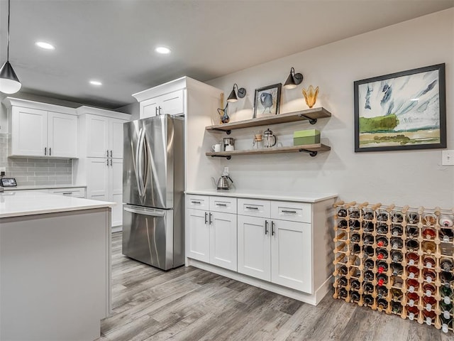 10505 Lyndon Rd, The Village, OK 73120 - kitchen featuring freestanding refrigerator, light wood-type flooring, light countertops, white cabinets, and recessed lighting