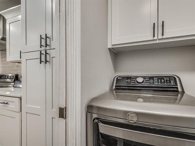 10505 Lyndon Rd, The Village, OK 73120 - washroom with washer / clothes dryer and cabinet space