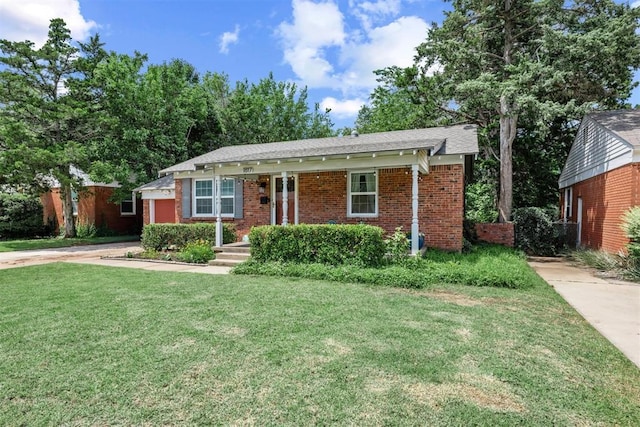1817 Westchester Dr, Oklahoma City, OK 73120 - view of front of home featuring a front lawn, brick siding, concrete driveway, and an attached garage