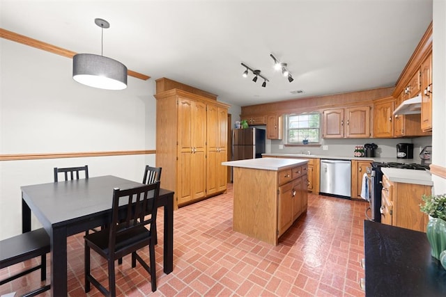 1817 Westchester Dr, Oklahoma City, OK 73120 - kitchen featuring stainless steel appliances, brick patterned flooring, a kitchen island, light countertops, and under cabinet range hood