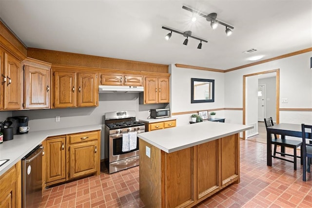 1817 Westchester Dr, Oklahoma City, OK 73120 - kitchen with appliances with stainless steel finishes, under cabinet range hood, brick patterned floors, light countertops, and ornamental molding