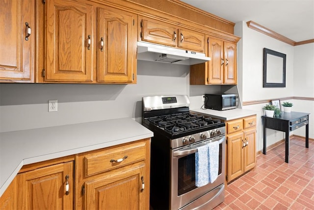 1817 Westchester Dr, Oklahoma City, OK 73120 - kitchen with appliances with stainless steel finishes, under cabinet range hood, brick flooring, light countertops, and ornamental molding