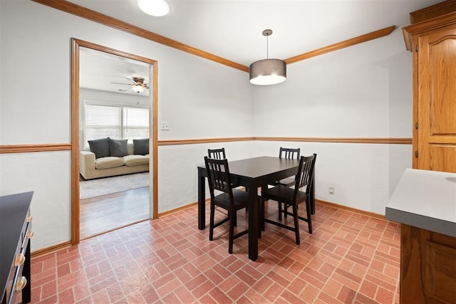 1817 Westchester Dr, Oklahoma City, OK 73120 - dining space featuring brick patterned flooring, ornamental molding, and a ceiling fan