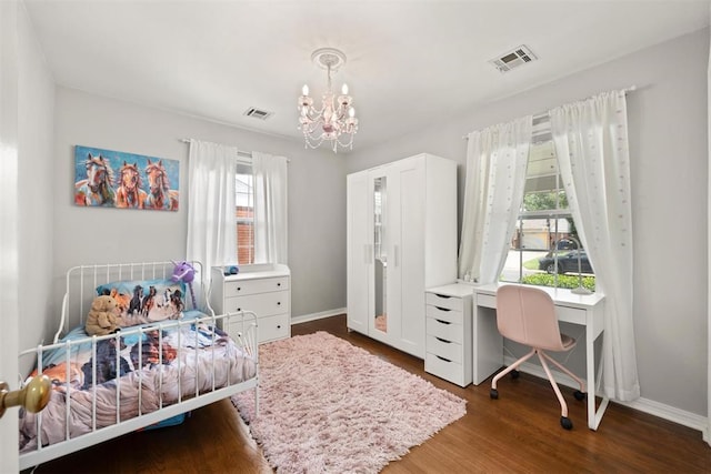 1817 Westchester Dr, Oklahoma City, OK 73120 - bedroom with a chandelier, wood finished floors, and a desk