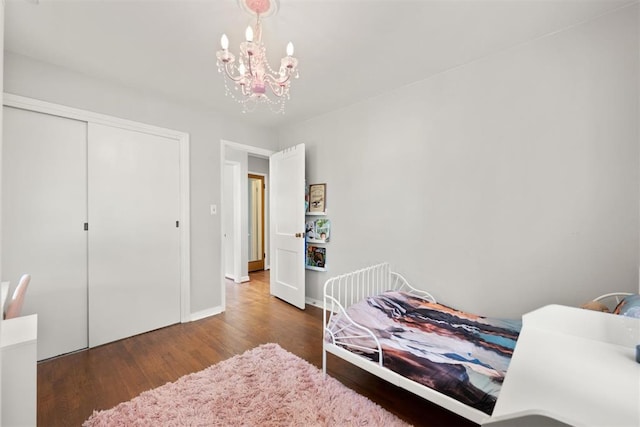 1817 Westchester Dr, Oklahoma City, OK 73120 - bedroom featuring wood finished floors, a chandelier, and a closet