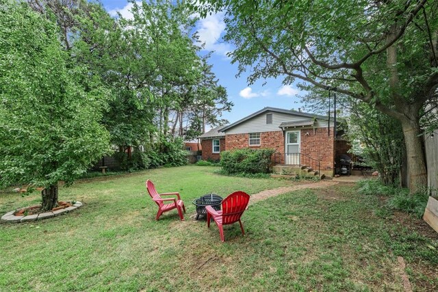 1817 Westchester Dr, Oklahoma City, OK 73120 - view of grassy yard with a fire pit