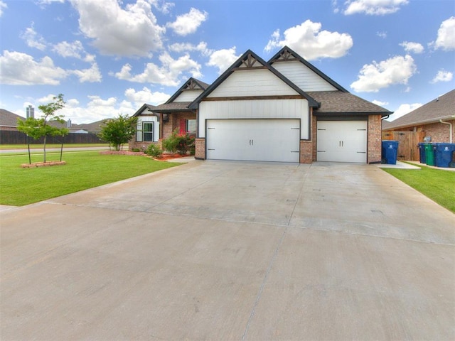 701 Bison Crossing Dr, Yukon, OK 73099 - view of front of property featuring an attached garage, brick siding, and concrete driveway