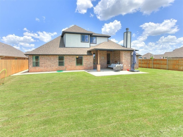 701 Bison Crossing Dr, Yukon, OK 73099 - rear view of property featuring a patio, a fenced backyard, a shingled roof, and a chimney