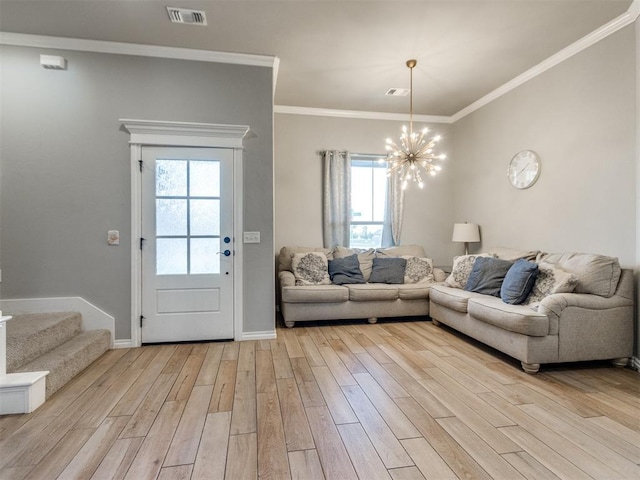 701 Bison Crossing Dr, Yukon, OK 73099 - living area featuring light wood-style flooring, a chandelier, ornamental molding, and stairs