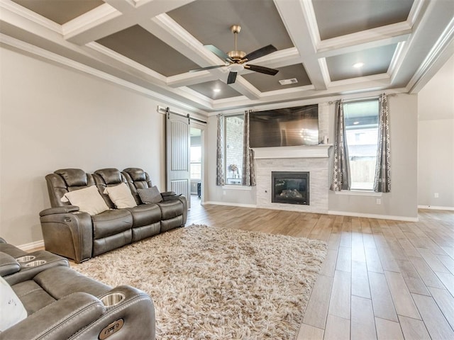 701 Bison Crossing Dr, Yukon, OK 73099 - living room with ceiling fan, wood finished floors, a barn door, coffered ceiling, and beamed ceiling