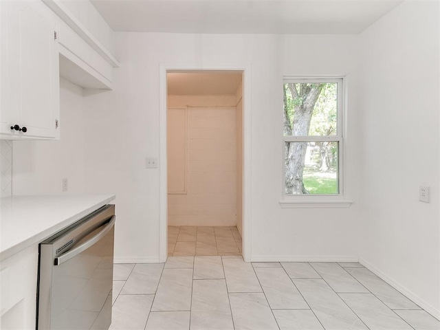213 E Haddock St, Norman, OK 73069 - kitchen featuring stainless steel dishwasher, light countertops, and white cabinets