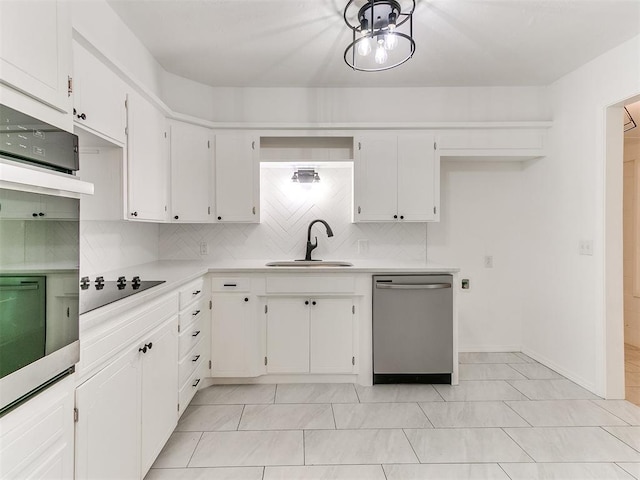 213 E Haddock St, Norman, OK 73069 - kitchen with dishwasher, black electric stovetop, wall oven, light countertops, and decorative backsplash