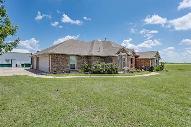 2858 Fields Rd, El Reno, OK 73036 - view of front of house with brick siding, driveway, a front lawn, and an attached garage