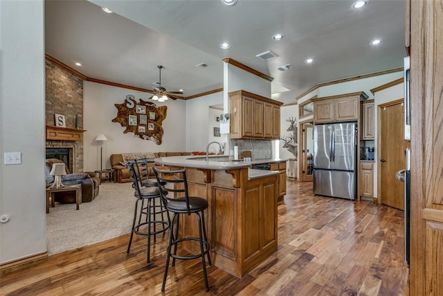 2858 Fields Rd, El Reno, OK 73036 - kitchen with freestanding refrigerator, ornamental molding, a peninsula, open floor plan, and a ceiling fan