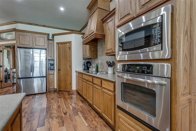 2858 Fields Rd, El Reno, OK 73036 - kitchen featuring stainless steel appliances, decorative backsplash, wood-type flooring, light countertops, and recessed lighting