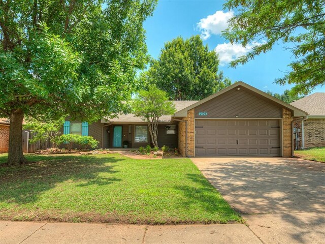 2104 Tanglewood Dr, Edmond, OK 73013 - view of front of home with a garage, driveway, and brick siding