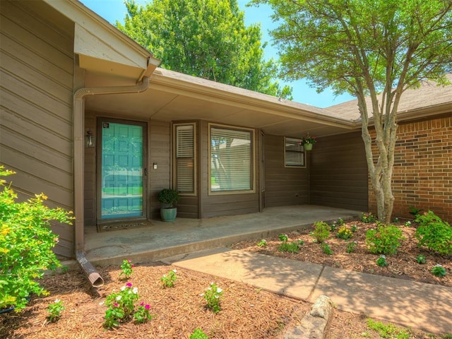 2104 Tanglewood Dr, Edmond, OK 73013 - property entrance with a patio area and brick siding