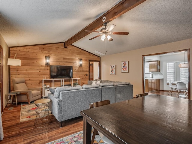 2104 Tanglewood Dr, Edmond, OK 73013 - living room with wooden walls, a ceiling fan, a textured ceiling, and wood finished floors