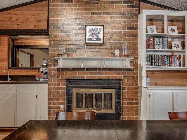 2104 Tanglewood Dr, Edmond, OK 73013 - dining area view of a fireplace and wood walls