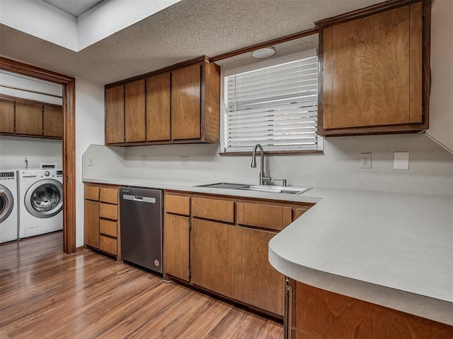 2104 Tanglewood Dr, Edmond, OK 73013 - kitchen with dishwasher, washing machine and clothes dryer, light wood-style flooring, light countertops, and a textured ceiling