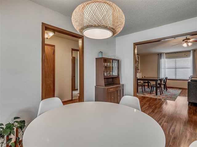 2104 Tanglewood Dr, Edmond, OK 73013 - dining space featuring wood finished floors, a textured ceiling, and ceiling fan