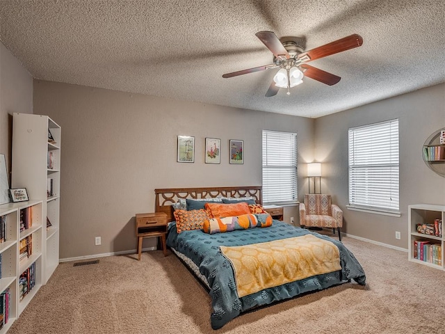 2104 Tanglewood Dr, Edmond, OK 73013 - carpeted bedroom with a textured ceiling and ceiling fan