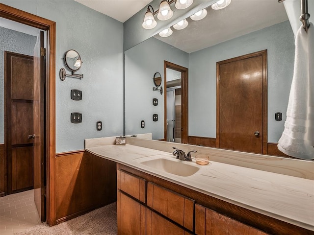 2104 Tanglewood Dr, Edmond, OK 73013 - bathroom featuring vanity and a textured wall