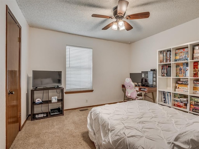 2104 Tanglewood Dr, Edmond, OK 73013 - bedroom featuring carpet flooring, a textured ceiling, and a ceiling fan