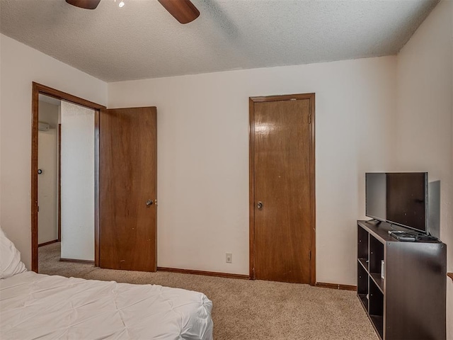 2104 Tanglewood Dr, Edmond, OK 73013 - carpeted bedroom featuring a textured ceiling and a ceiling fan