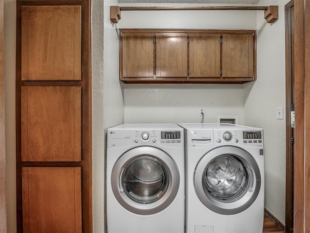 2104 Tanglewood Dr, Edmond, OK 73013 - laundry room featuring cabinet space, separate washer and dryer, and a textured wall