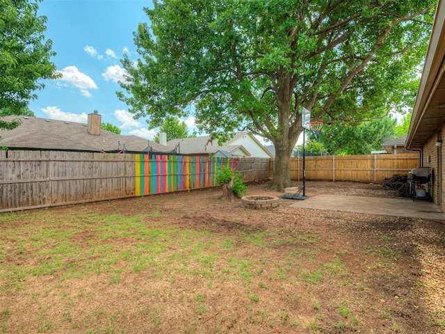 2104 Tanglewood Dr, Edmond, OK 73013 - fenced backyard with a patio and an outdoor fire pit