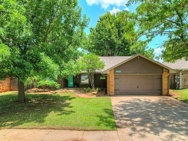 2104 Tanglewood Dr, Edmond, OK 73013 - view of front facade featuring a garage, driveway, a front yard, and brick siding