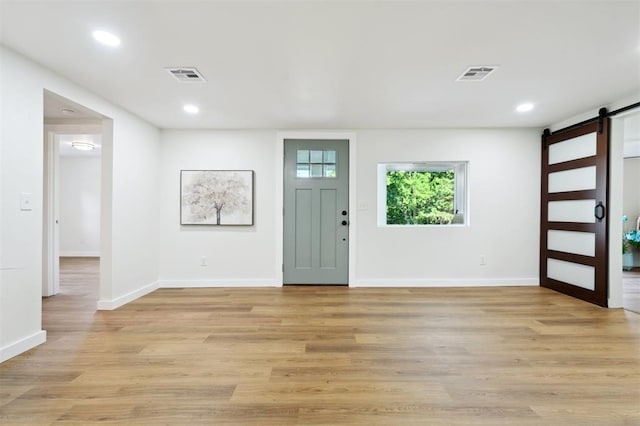 8300 S Anderson Rd, Oklahoma City, OK 73150 - entryway featuring a barn door, recessed lighting, and light wood-type flooring
