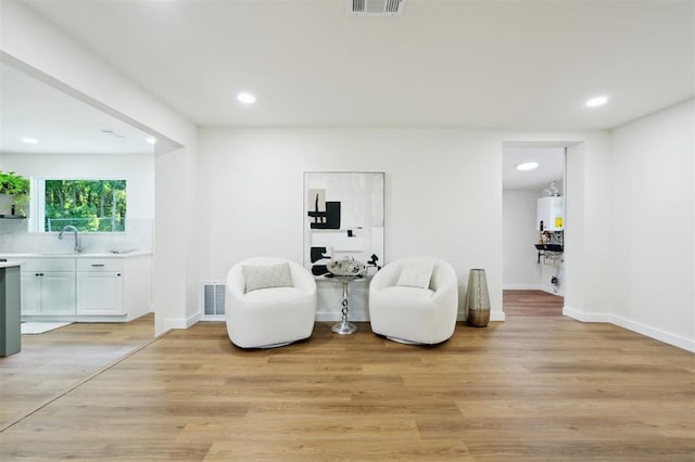 8300 S Anderson Rd, Oklahoma City, OK 73150 - sitting room featuring recessed lighting, light wood-style flooring, and water heater