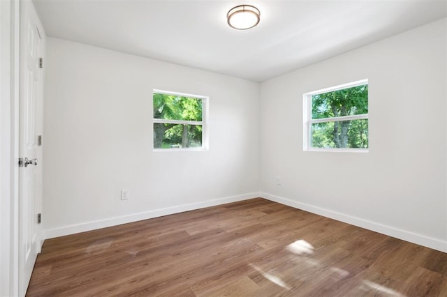 8300 S Anderson Rd, Oklahoma City, OK 73150 - unfurnished room featuring baseboards and wood finished floors
