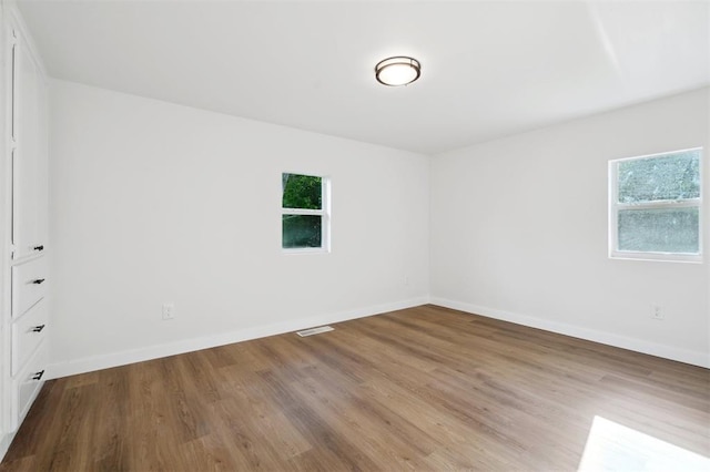 8300 S Anderson Rd, Oklahoma City, OK 73150 - empty room featuring wood finished floors and baseboards