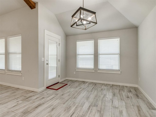 6713 NW 149th St, Oklahoma City, OK 73142 - unfurnished dining area with lofted ceiling, a chandelier, and light wood-style flooring