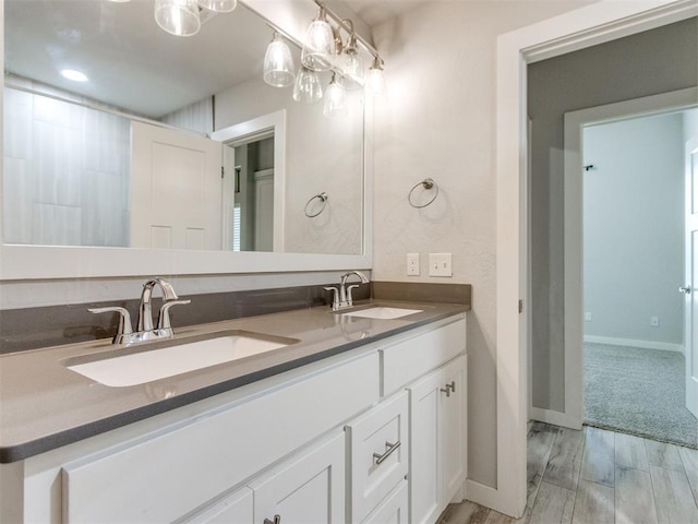 6713 NW 149th St, Oklahoma City, OK 73142 - bathroom with double vanity and wood finished floors