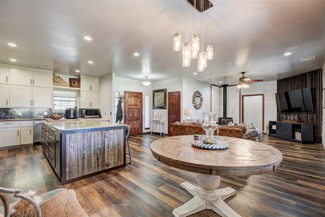 1187 County St Unit 2976, Blanchard, OK 73010 - kitchen featuring stainless steel appliances, a wood stove, white cabinetry, a ceiling fan, and recessed lighting