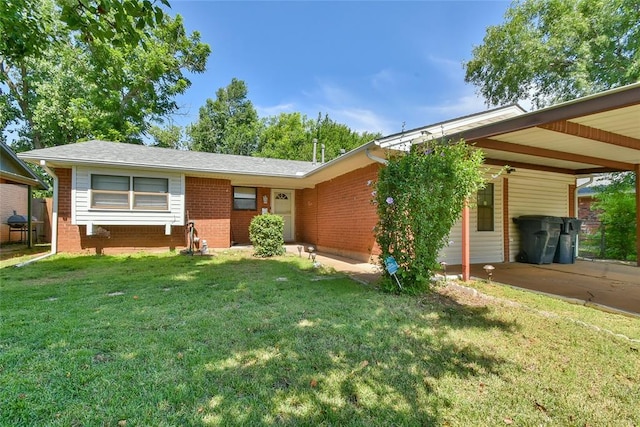 5505 S Dimple Dr, Oklahoma City, OK 73135 - ranch-style home with a front lawn, brick siding, and a carport